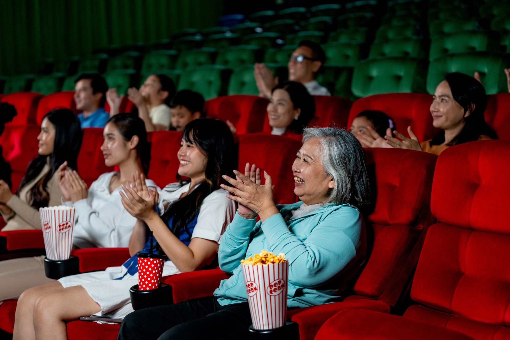 Audience clapping together in a theater setting