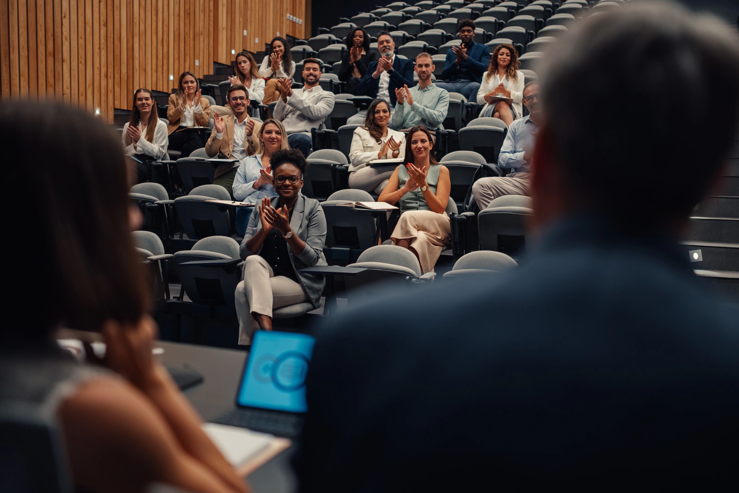 Audience applauding after a conference presentation
