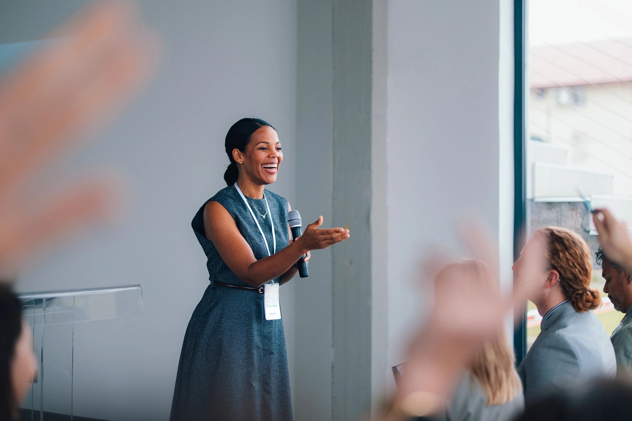 Speaker leading an engaged audience during a live conference workshop
