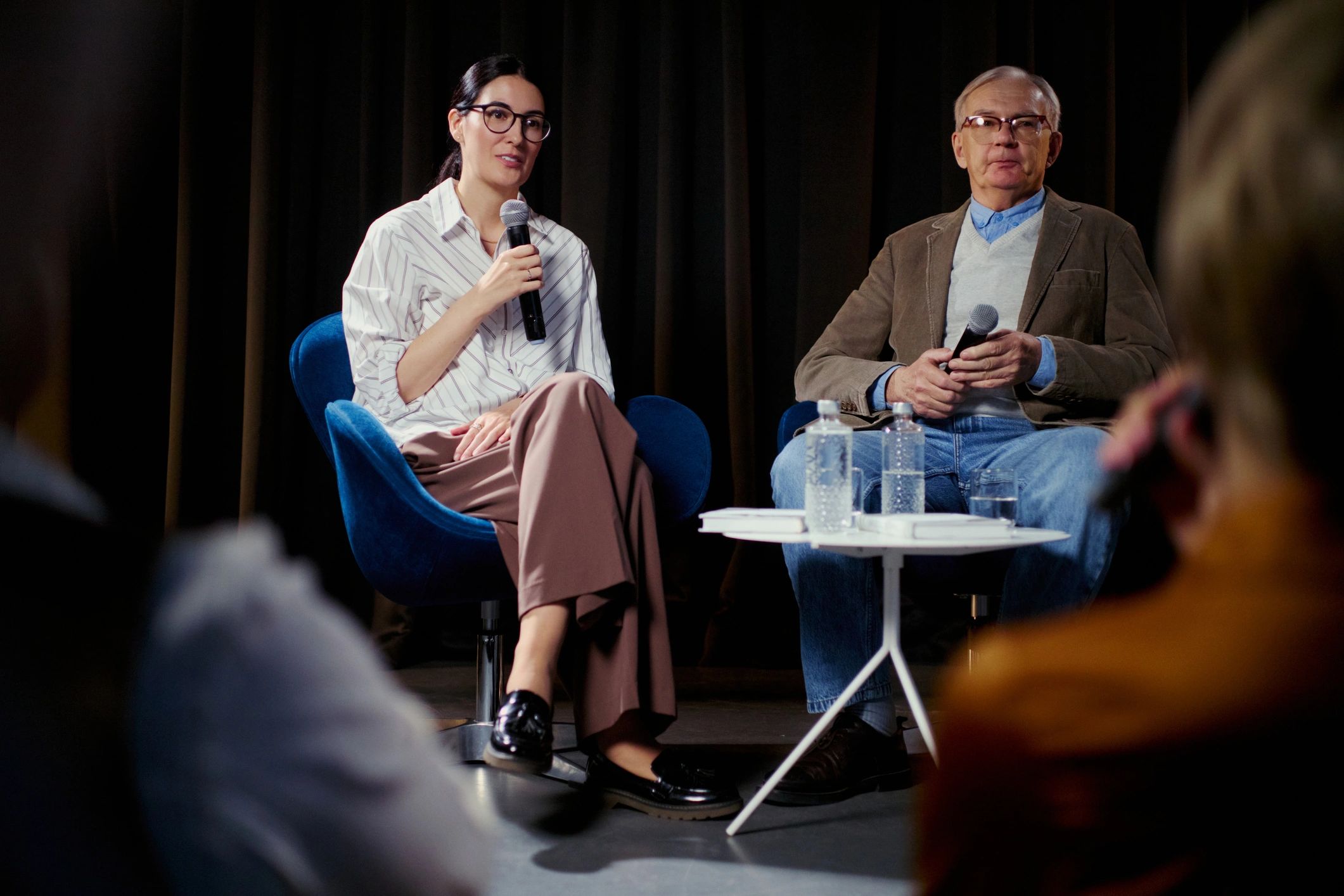 Speakers in conversation on stage during a live summit session